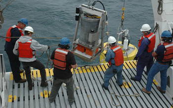 Men deploying of the Environmental Sample Processor (ESP) in the ocean