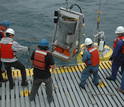 Men deploying of the Environmental Sample Processor (ESP) in the ocean