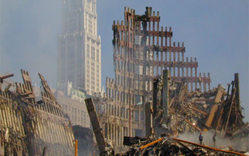 Photo of the Woolworth Building in New York City behind the collapsed World Trade Center.