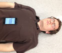 A smart phone placed on a man's chest to monitor breathing