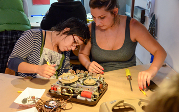 two visitors working at the Tinkering Social club