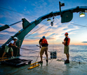 Scientists retrieving a CTD rosette from the ocean