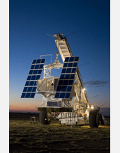 The SUNRISE telescope in its gondola hangs suspended from a crane-like launch vehicle