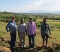 Seifu Tilahun stands with community farmers and a USAID representative in Ethiopia