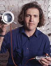 Photo of Saul Griffith with his eyeglass lens 'printer.'