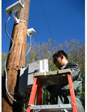 Dezhen Song of Texas A&M University testing robotic camera used to find ivory-billed woodpecker