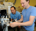 Scientists Mak Saito and Matthew McIlvin using a machine to separate individual proteins