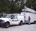 A photo of a truck carrying NEON instruments and a photo of the NEON instrument set up.
