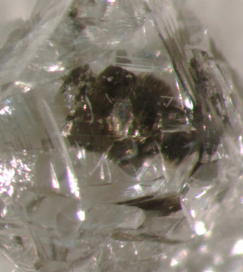 an optical photomicrograph of a sulfide-inclusion-bearing rough diamond from Botswana.