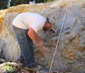 Biogeochemist Keith Morrison sampling an outcrop of blue clay in the Oregon deposit.