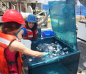 Researchers place sampling bottles in a container that mimicks the sea's light and temperature.