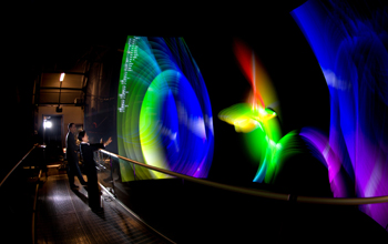 People on the bridge of the AlloSphere interacting with a hydrogen atom with spin