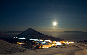 The moon shines over McMurdo Station in June, when there is 24-hour darkness during the winter