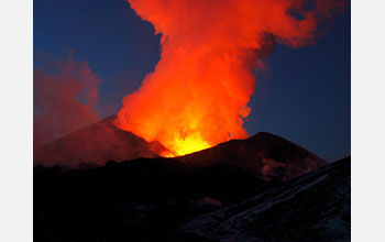 Lava from the Tolbachik volcano glows against evening sky