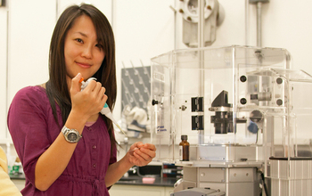 Scientist Pei-I Ku prepares a sample for a digital microscope used in the AIDS virus research.