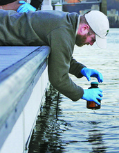 A student collecting a water sample