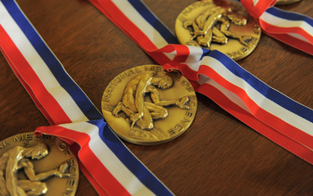 Three National Medals of Science laid out on a table