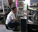 Photo of scientist Edward Dunlea calibrating an aerosol mass spectrometer at the Storm Peak Lab.