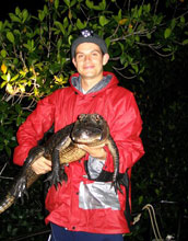 Photo of Adam Rosenblatt holding an alligator.