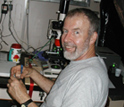 Photo of oceanographer Edward Carpenter looking at diatoms through a microscope.