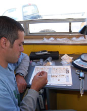 Analyzing artifacts recovered from screens in the field lab at Barger Gulch Locality B, Colorado.