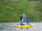 Photo of researchers taking a sediment core from a lake in Alaska.