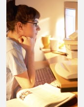 Woman stares at computer screen.