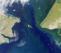 Satellite image showing the Bering Strait with U.S. on the right and Russia on the left.
