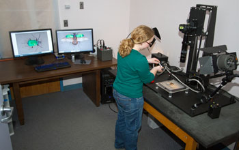 Photo of a researcher taking a high-quality image of a specimen.