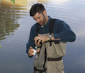 Scientist Mark Urban filters a tow net sample of zooplankton from a pond.