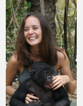 Photo of Duke University researcher Vanessa Woods with a bonobo in the field.