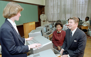 President Ronald Reagan with teacher and students in computer class