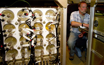 Air-sampling flasks used during HIPPO flights and researcher Andy Watt on the plane