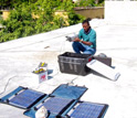 Photo of Louis Obenson installing GPS equipment in Port-au-Prince.