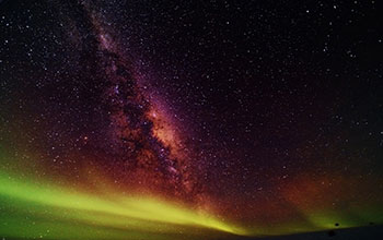 This picture is of our galactic center with a very weak aurora in the foreground