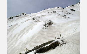 Photo of zebra stripes of dust and snow, visible on the snow surface in Colorado's mountains.