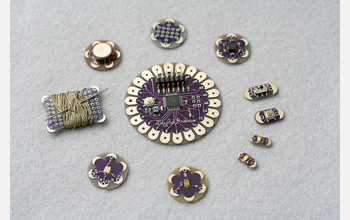 Photo of a circular array of sewable electronic components forming an interactive embroidery.