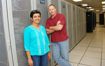 Photo of Jay Aikat and Michael Reiter in a machine room.