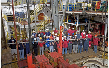 Expedition 317 participants celebrate the recovery of a core from the deepest hole drilled.