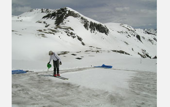 Photo of Chris Landry carrying out simulated dust effects on snowmelt.
