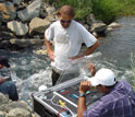 Photo of P.V. Sundareshwar with co-authors Berdanier and Honomichl analyzing water quality.