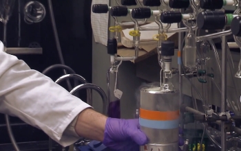 chemist holding a supercooled cylinder