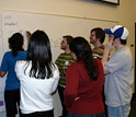 Photo of college chemistry and design students collaborating on scientific concepts.