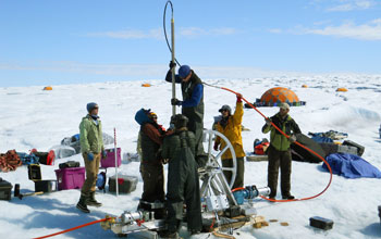 Team of scientists in Antaractica drilling a borehole