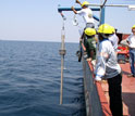 Photo of researchers conducting sediment coring to retrieve samples from Lake Tanganyika's floor.