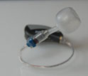 This photo shows a hybrid in-ear monitor-hearing aid technology from Asius.