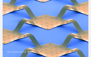 High magnification SEM image of interconnected Si photodetector pixels and electronics on substrate.