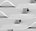 Close-up of the silicon photodetector pixels and electronics interconnected by arc-shaped ribbons.