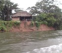 A family home on a low bluff above an Amazonian river.