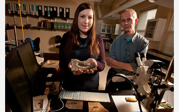 Lauren Sallan and Michael Coates handle an actinopterygian fossil in their lab.